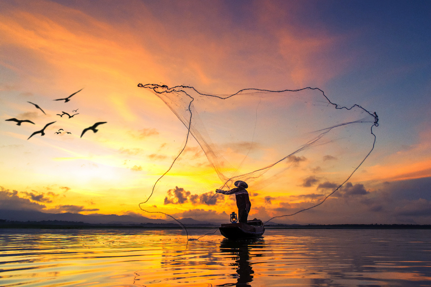 Fisherman fishing at lake in Morning, Thailand.